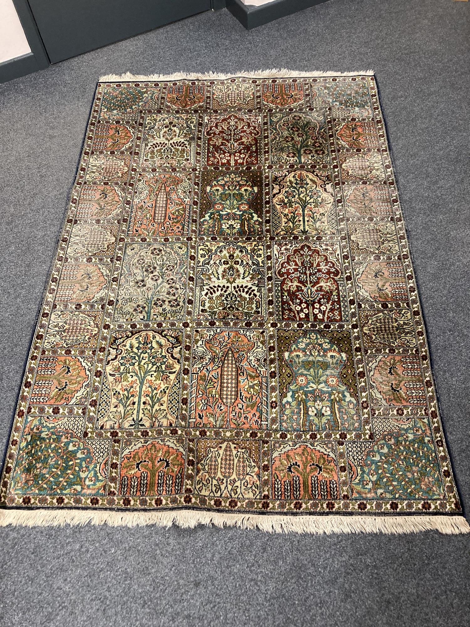 A Ghom silk rug of compartmentalised design,