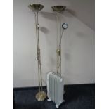 A Micromark oil filled radiator together with two brass effect floor lamps.