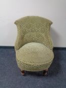 A 20th century bedroom chair upholstered in a green brocade fabric