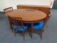 A 1970's teak six piece dining room suite comprising of low double door sideboard fitted three