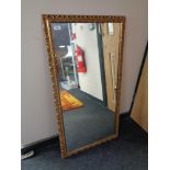 A gilt framed mirror.