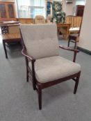 A stained beech framed armchair in buttoned fabric