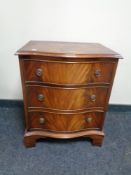 A Georgian style mahogany serpentine fronted three drawer chest,