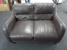 A brown leather two seater settee