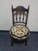 An antique ebonised bedroom chair with a tapestry upholstered seat