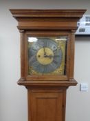 A continental oak longcase clock with brass and metal dial,