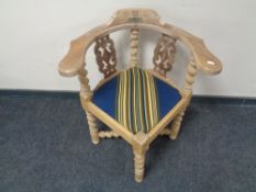 An early 20th century continental oak corner chair on barley twist legs