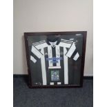 A signed Newcastle United football shirt with accompanying photograph of Steven Taylor in frame.