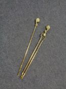 A late nineteenth century brass fire tongs and poker with claw and ball handles