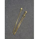 A late nineteenth century brass fire tongs and poker with claw and ball handles