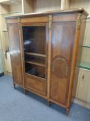 A continental inlaid mahogany triple door cabinet with brass mounts