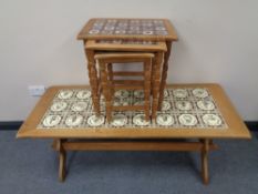 A blond oak tiled refectory coffee table together with a nest of tables with tiled tops