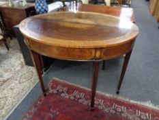 A pair of Regency style inlaid mahogany Demi-lune hall tables