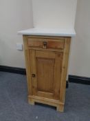 An early twentieth century pine pot cupboard with marble top