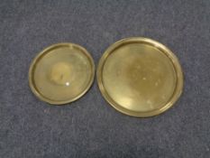 Two circular brass trays