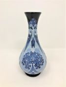 A modern Moorcroft 'Forget Me Not' pattern vase on blue ground, designed by Kerry Goodwin,