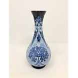 A modern Moorcroft 'Forget Me Not' pattern vase on blue ground, designed by Kerry Goodwin,