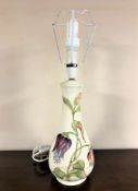 A Moorcroft table lamp on cream ground, height 40cm excluding bulb.