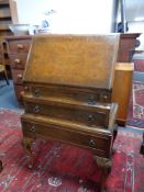 An Edwardian walnut writing bureau fitted three drawers beneath on cabriole legs