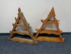 Two triangular wall mounted shelves.