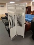 A painted louvre three-way folding room divider