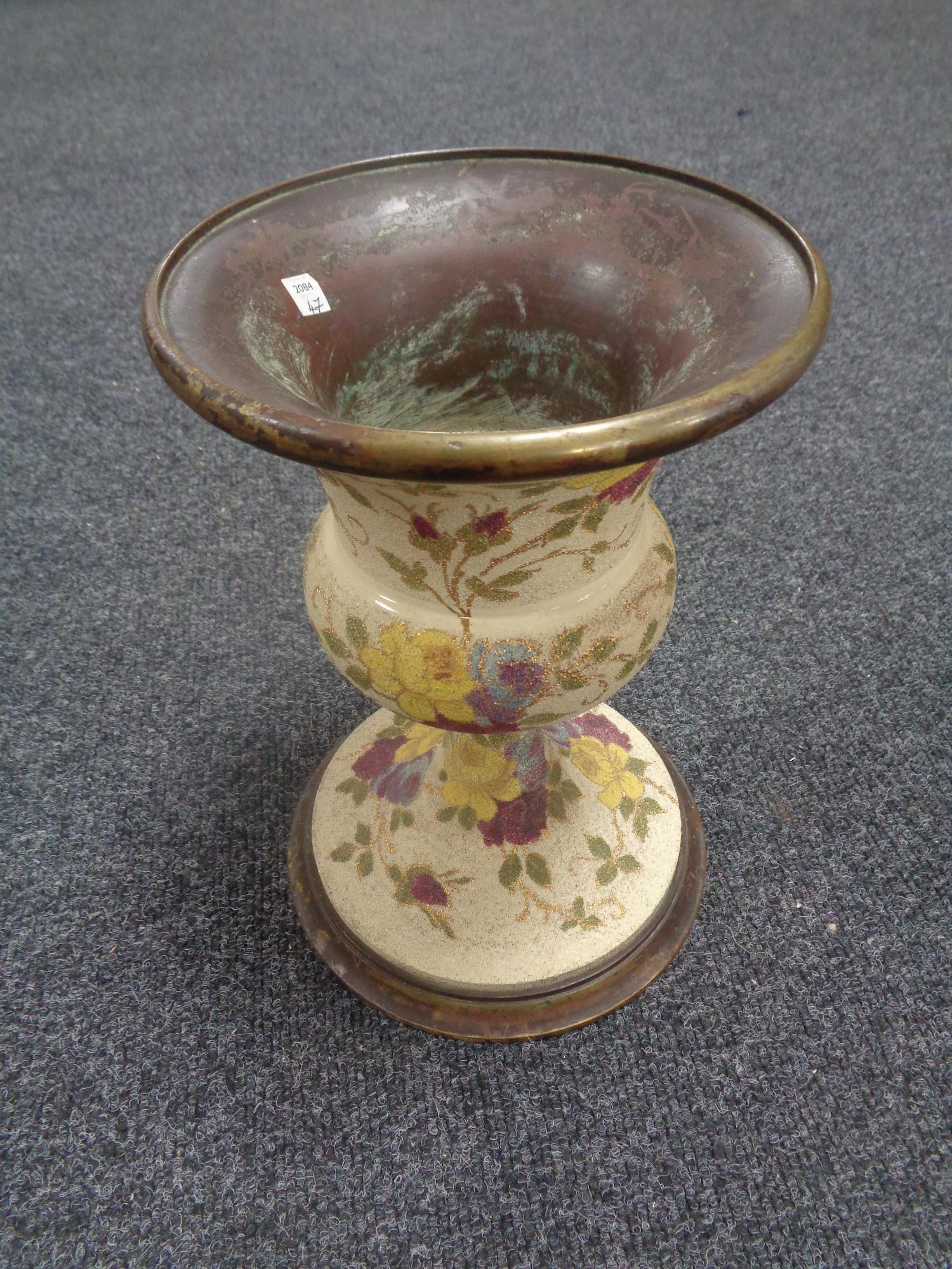 A nineteenth century brass and ceramic jardiniere stand