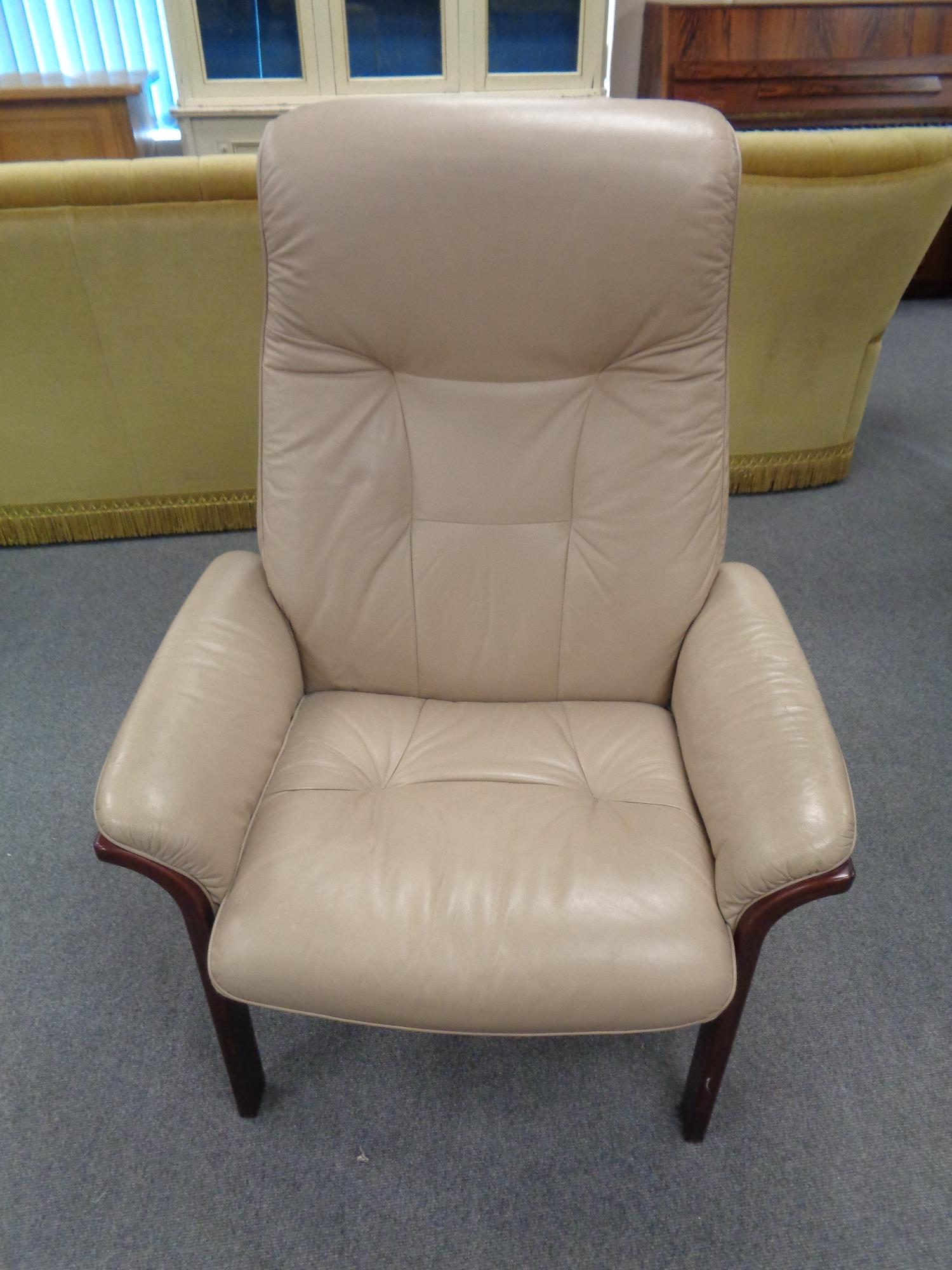 A late twentieth century stained beech framed armchair in beige leather
