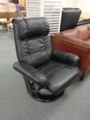 A black leather swivel relaxer armchair