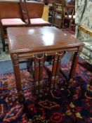 A mahogany occasional table fitted two tables beneath