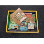 A plastic crate containing quantity of vintage and later games and puzzles