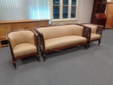 An antique mahogany framed three piece lounge suite in golden brocade fabric