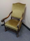 An early twentieth century carved beech armchair in golden dralon