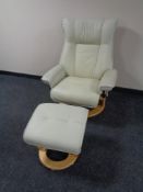 A cream leather adjustable armchair with matching footstool