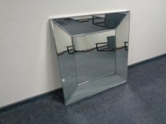 A contemporary all glass framed bevel edged wall mirror (A/F).