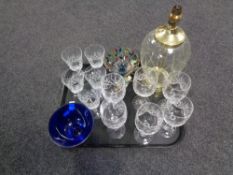A tray containing assorted glassware to include glass and brass table lamp base,