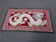 An Eastern beaded and silk work wall hanging depicting a dragon.