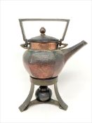 An Arts & Crafts hammered copper teapot on stand,