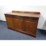 A 20th century mahogany triple door sideboard, fitted three drawers above.