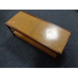 A 20th century teak extending coffee table with under shelf.