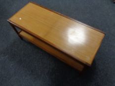 A 20th century teak extending coffee table with under shelf.