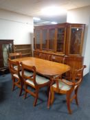 An inlaid yew wood twin pedestal dining table together with six chairs, two carvers, four singles.