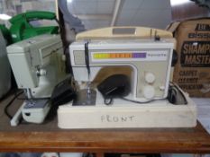 A cased Toyota electric sewing machine together with a Capri electric sewing machine (both with
