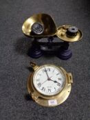 A set of kitchen scales with weights, together with a brass ship's style wall clock.