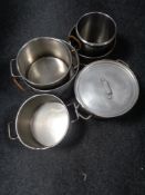 Six aluminium and stainless steel catering cooking pots, one with lid.