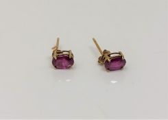 A pair of 9ct gold ruby earrings.