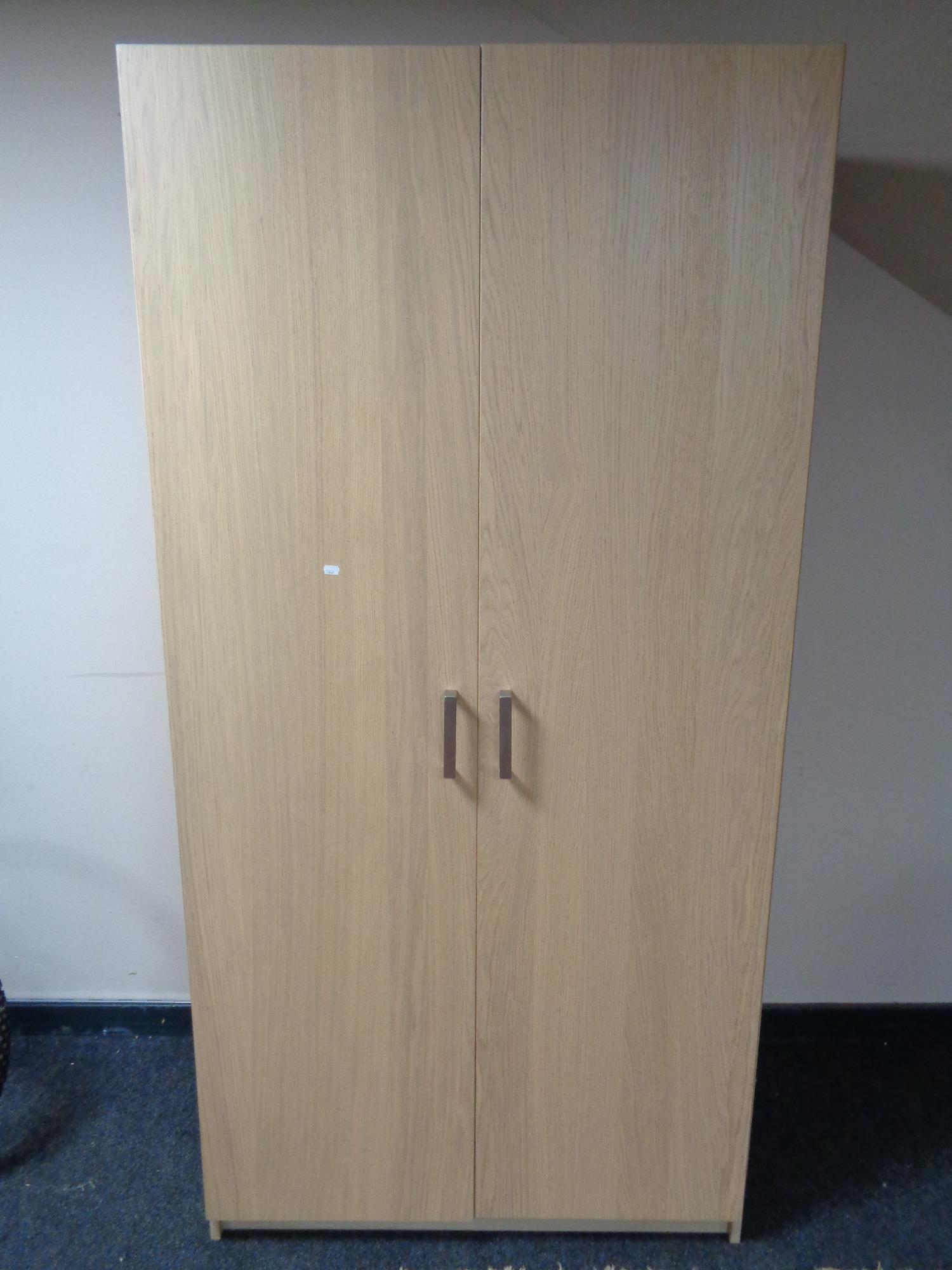 A contemporary double door wardrobe, fitted with interior lighting.