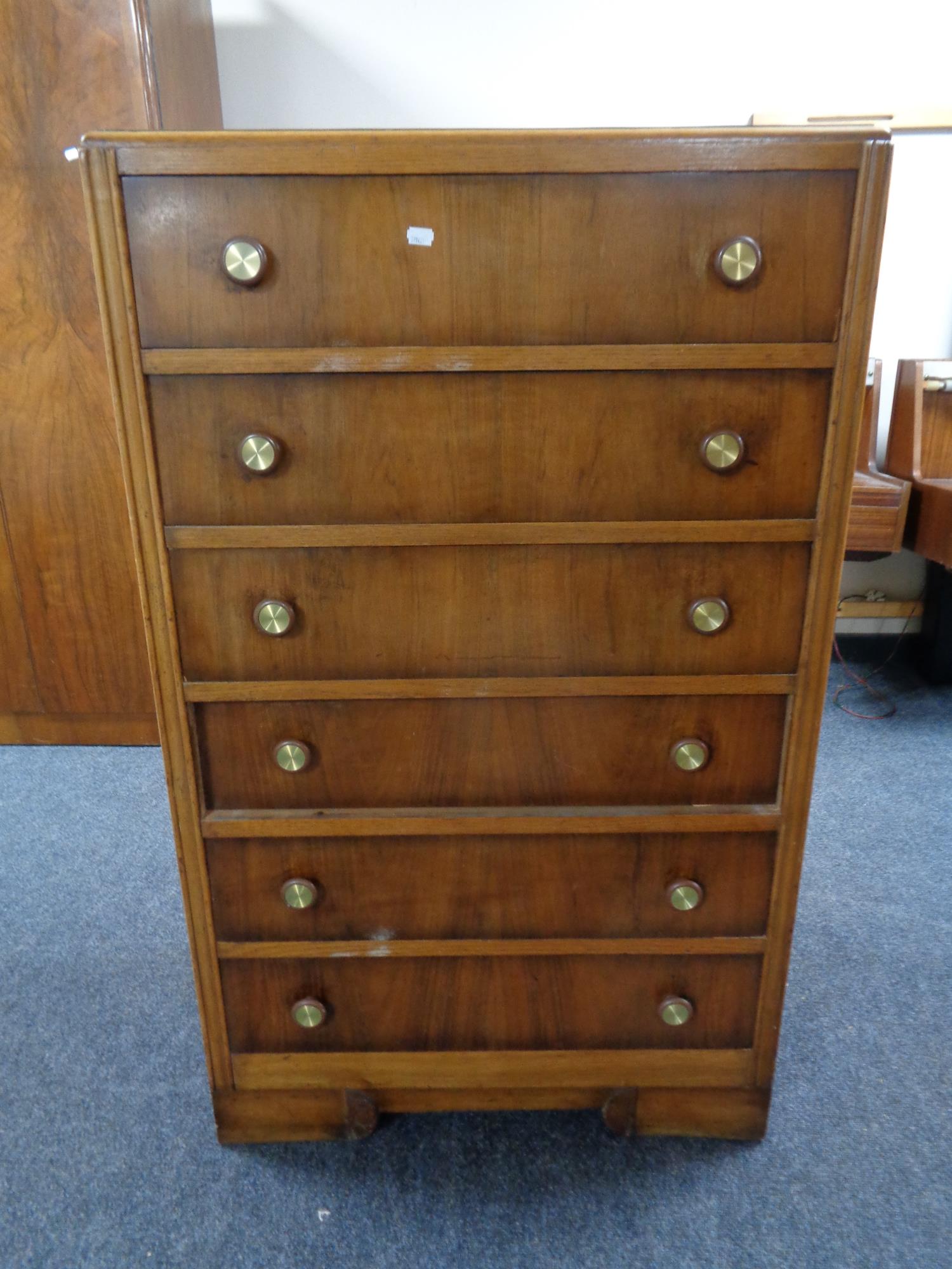 A mid 20th century six drawer chest.