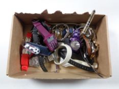 A box containing a collection of assorted lady's and gent's wristwatches.