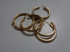 Two pairs of 9ct gold hoop earrings together with a further gold hoop earring.
