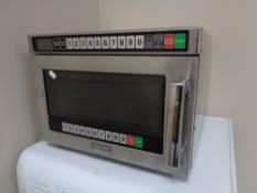 A stainless steel Sharp R-1900M commercial microwave.
